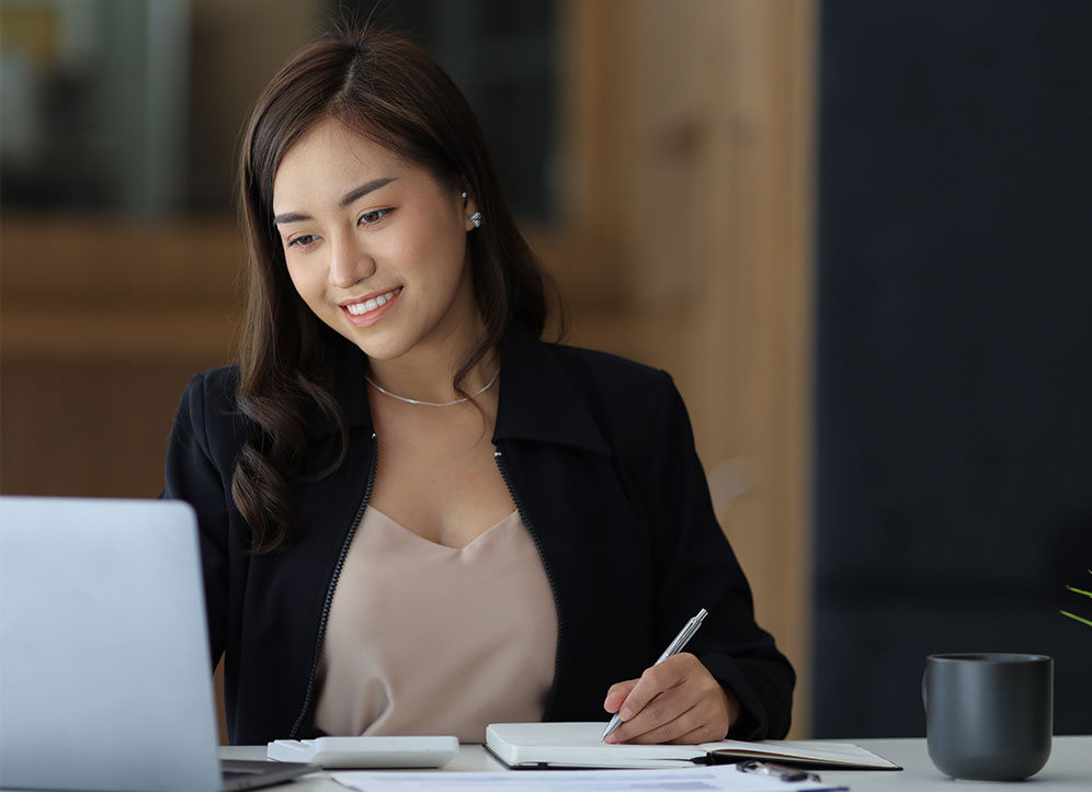 Professional services associate working on laptop in office