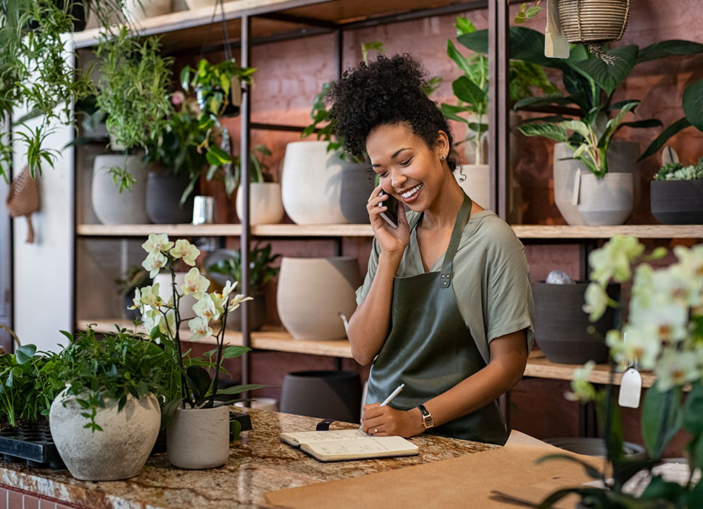 Florist takes an order on the phone at flower shop