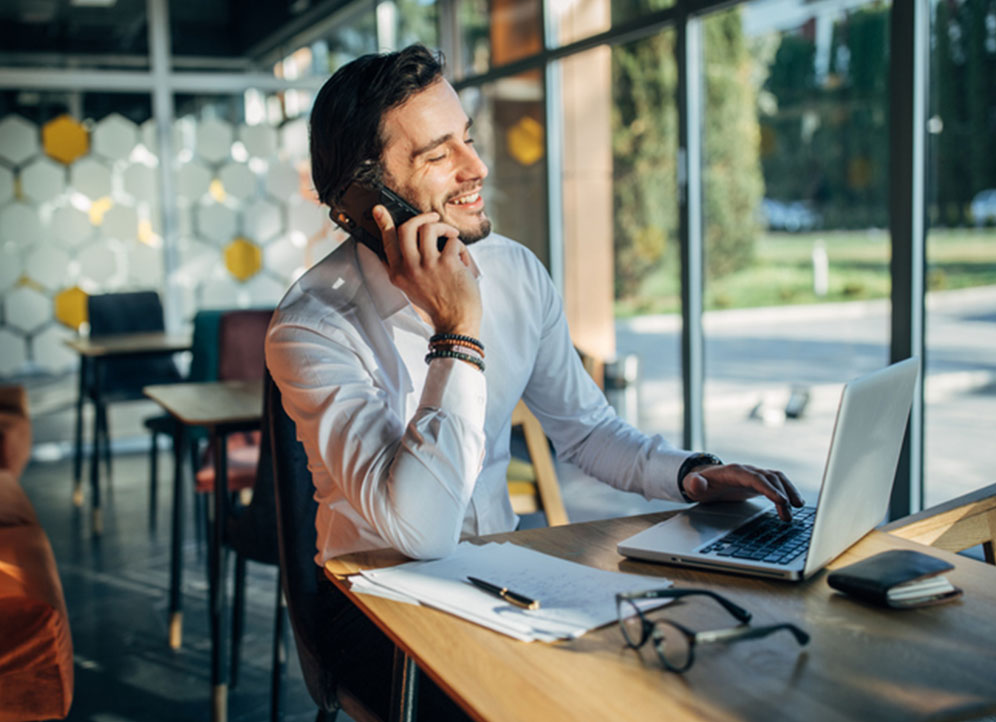 Man in co-working space talking to colleague about startup business