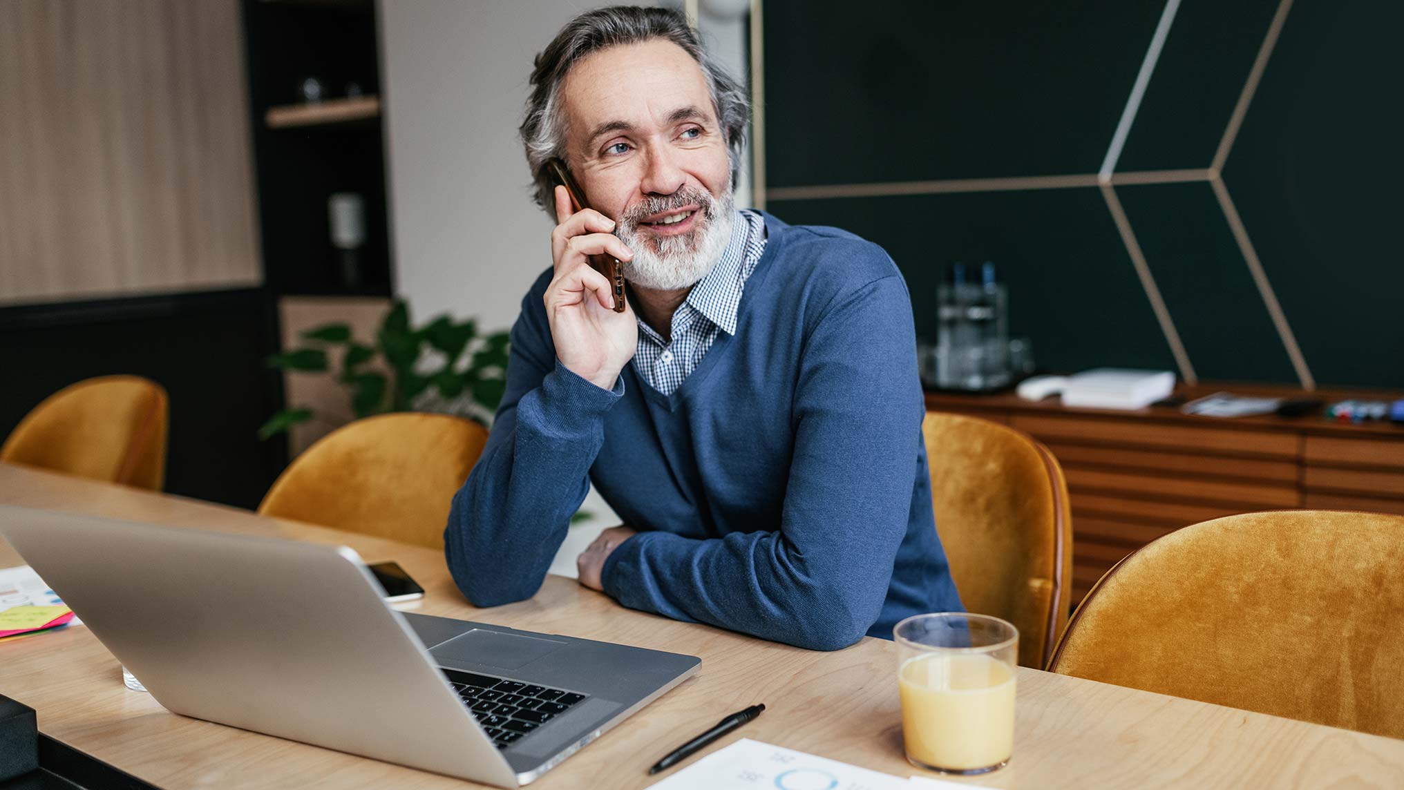 Man talking on phone at desk