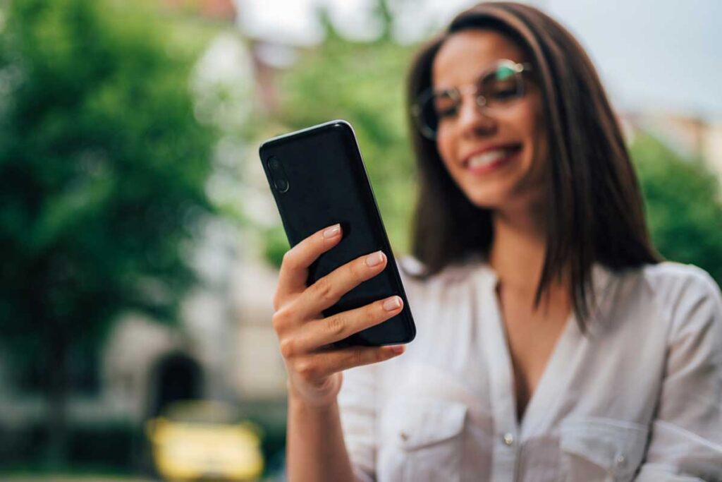 Woman looking at phone outside